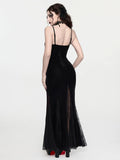 Rear three-quarter view of black velvet mermaid dress with spaghetti straps and lace godet panels