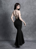 Back view of black gothic maxi dress with crisscross lace-up open back and flared hem