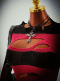 Close view of red and black rib-knit round neckline and curved chest cutout