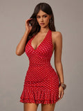Close front view of red and white polka dot dress highlighting the halter V neckline and fitted bodice