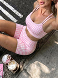 Close view of pink gingham fabric and solid waistband on matching active set