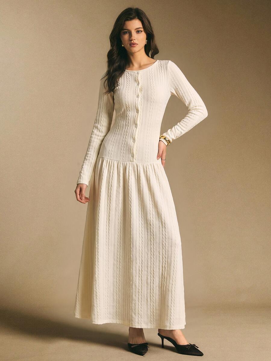 Front view of an ivory white textured long-sleeve maxi dress with button front, fitted bodice, and flared skirt