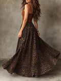 Rear angled view of brown strappy bodice and sweeping leopard-print maxi skirt