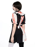 Rear three quarter view of black white clown dress with red splatter and back bow