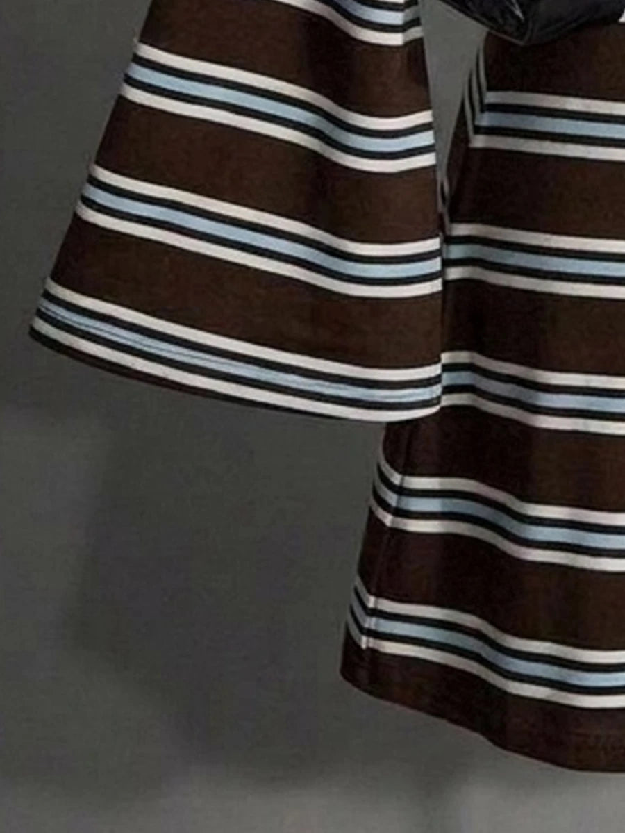 Close-up of flared sleeve and hem on brown striped knit mini dress