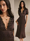 Brown polka-dot midi dress close-up with lace V-neck and puff sleeves