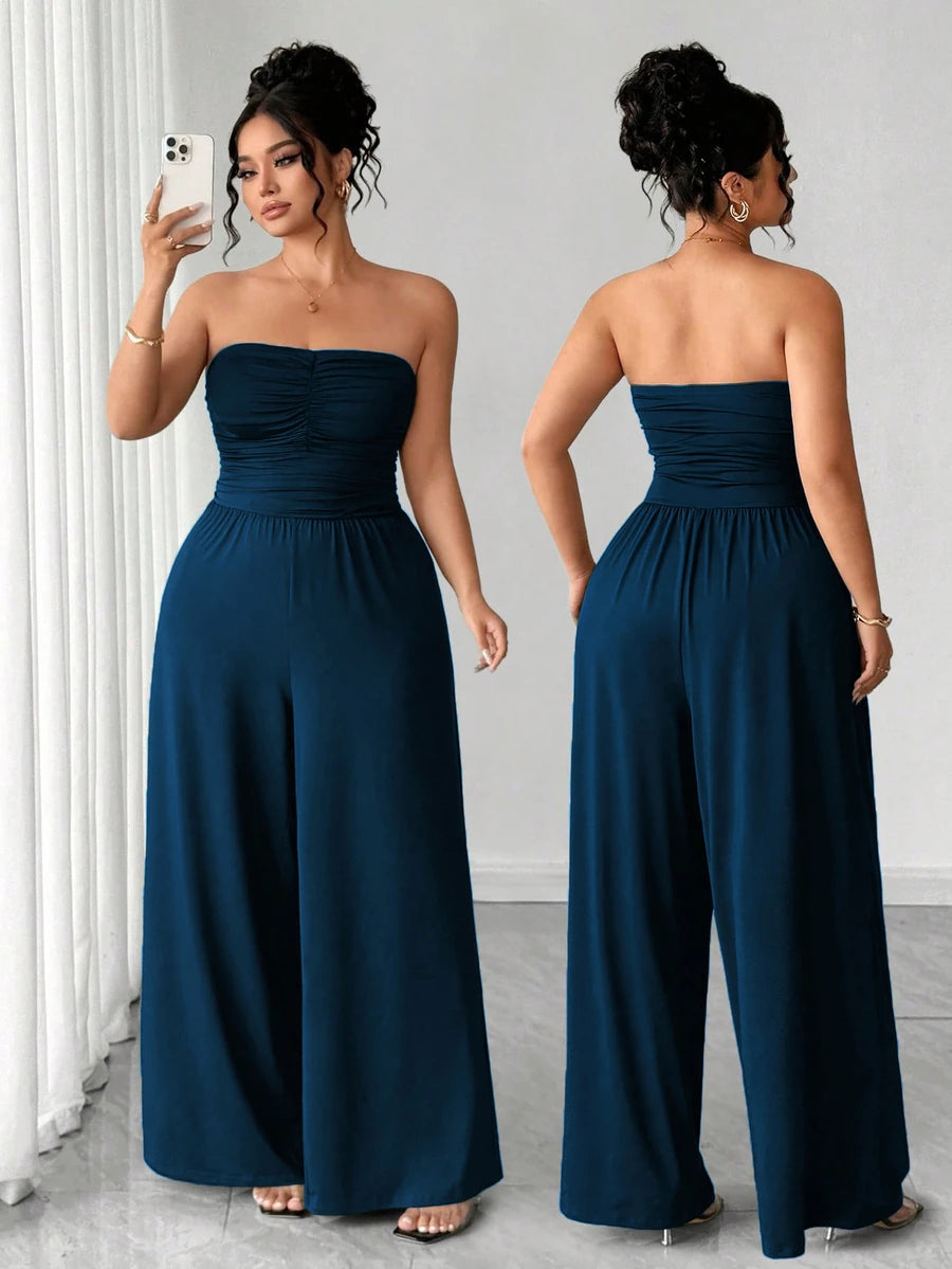 Front and back views of navy strapless ruched wide-leg jumpsuit