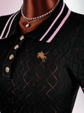 Close-up of black knit dress bodice with pink-striped polo collar, gold buttons, horse embroidery, and geometric openwork