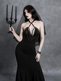 Close-up front view of black halter dress bodice with metallic chain details and cutout straps