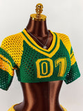 Close view of green yellow V-neck knit crop top with 07 numeric motif