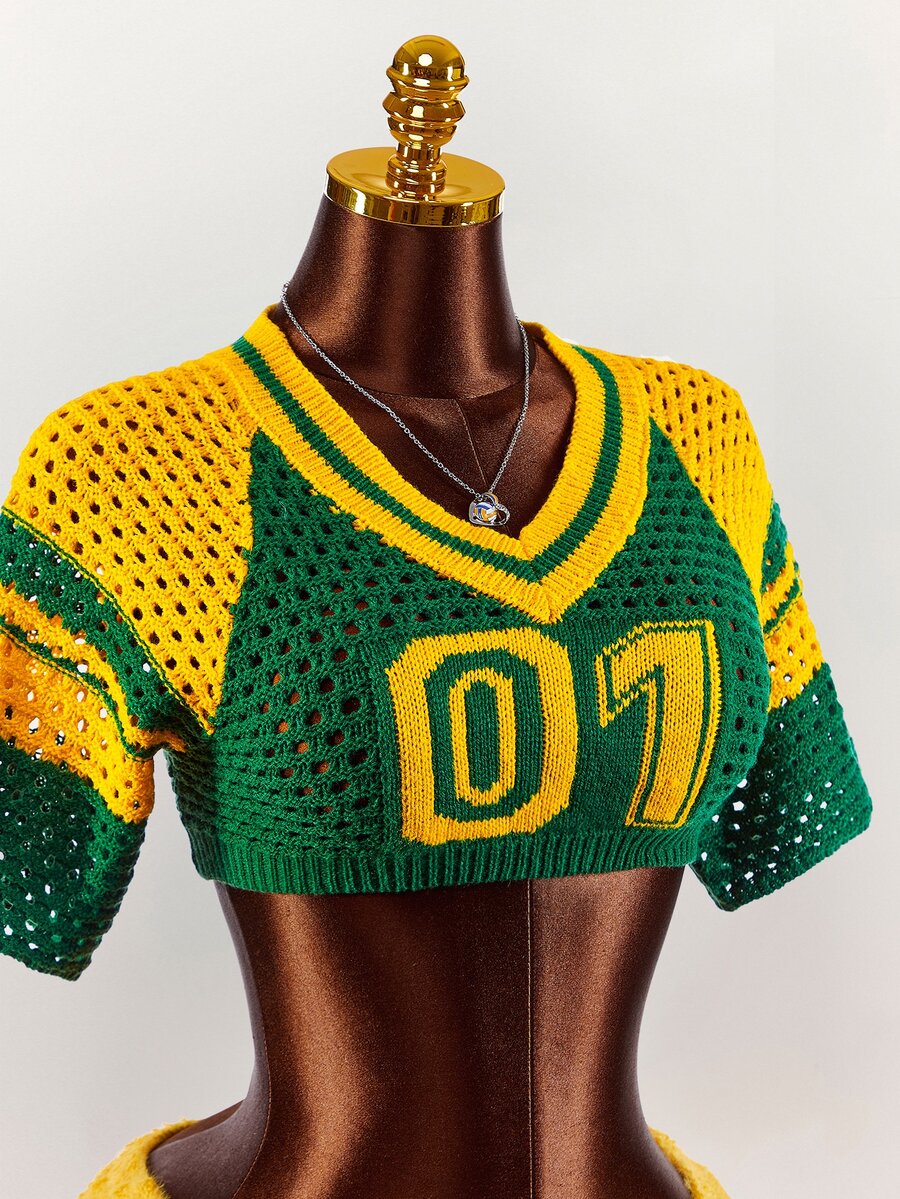 Close view of green yellow V-neck knit crop top with 07 numeric motif