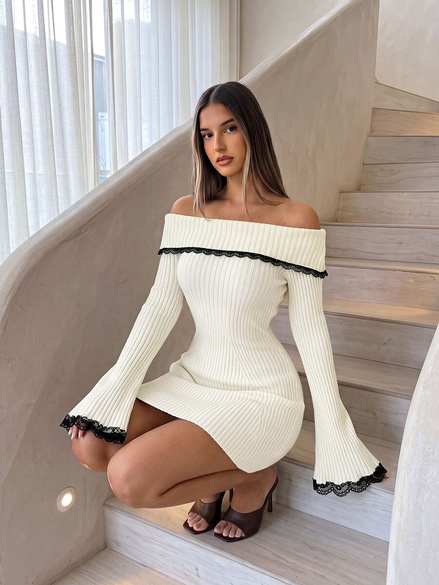 Front view of cream rib-knit off-shoulder mini dress with black lace trim