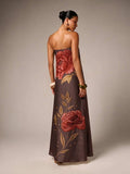 Back view of brown strapless maxi gown showing rose embroidery and leafy satin detail