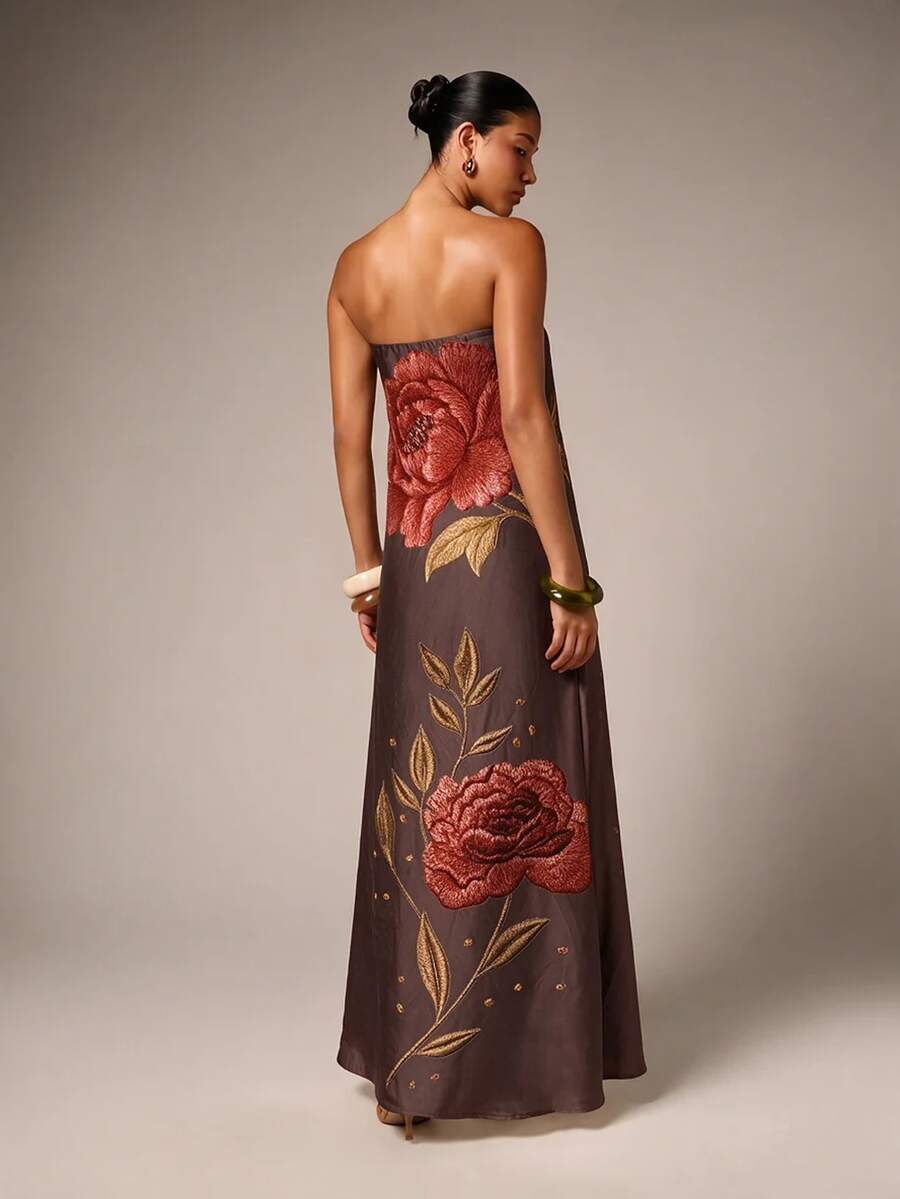 Back view of brown strapless maxi gown showing rose embroidery and leafy satin detail