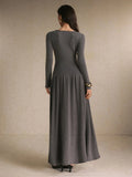 Front view of a charcoal gray long-sleeve maxi dress with round neckline, button front, fitted bodice, and gathered skirt