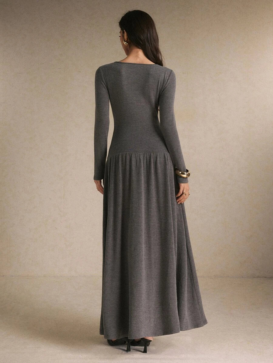Front view of a charcoal gray long-sleeve maxi dress with round neckline, button front, fitted bodice, and gathered skirt
