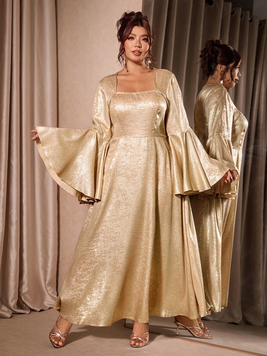 Model wearing gold foil-finish gown with tiered bell sleeves and full skirt