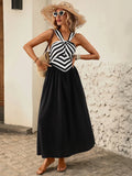 Full front view of striped halter A-line midi dress styled for a vacation outing