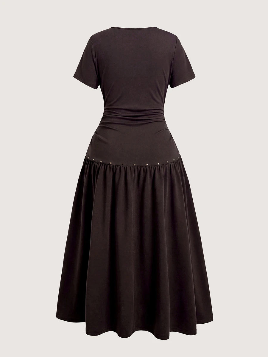 Back view of dark brown midi dress with gathered waist and flared pleated skirt