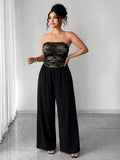 Full view of black strapless wide-leg jumpsuit with lace bodice