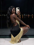 Back view of black and gold fringe halter midi dress with open tie-back