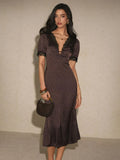 Front three-quarter brown polka-dot midi dress with lace trim and handbag