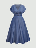A blue A-line midi dress with a V-neckline, short puff sleeves, and a buttoned waist detail, shown against a solid light gray background.