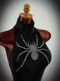 Close-up of rhinestone spider motif on black halter unitard
