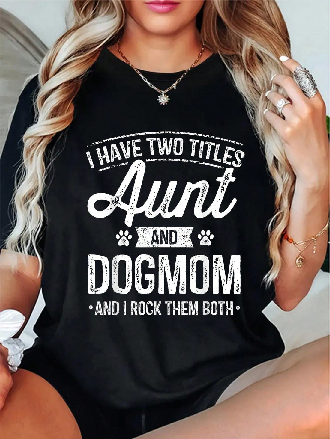 Celebrate two amazing titles with one shirt! This Aunt & Dog Mom Title Tee is the perfect gift for the dog-loving aunt in your life. Show off your love for your furry family members and your awesome aunt status in this fun and quirky tee.