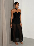 Black lace-up halter maxi dress with semi-sheer mesh skirt for evening styling