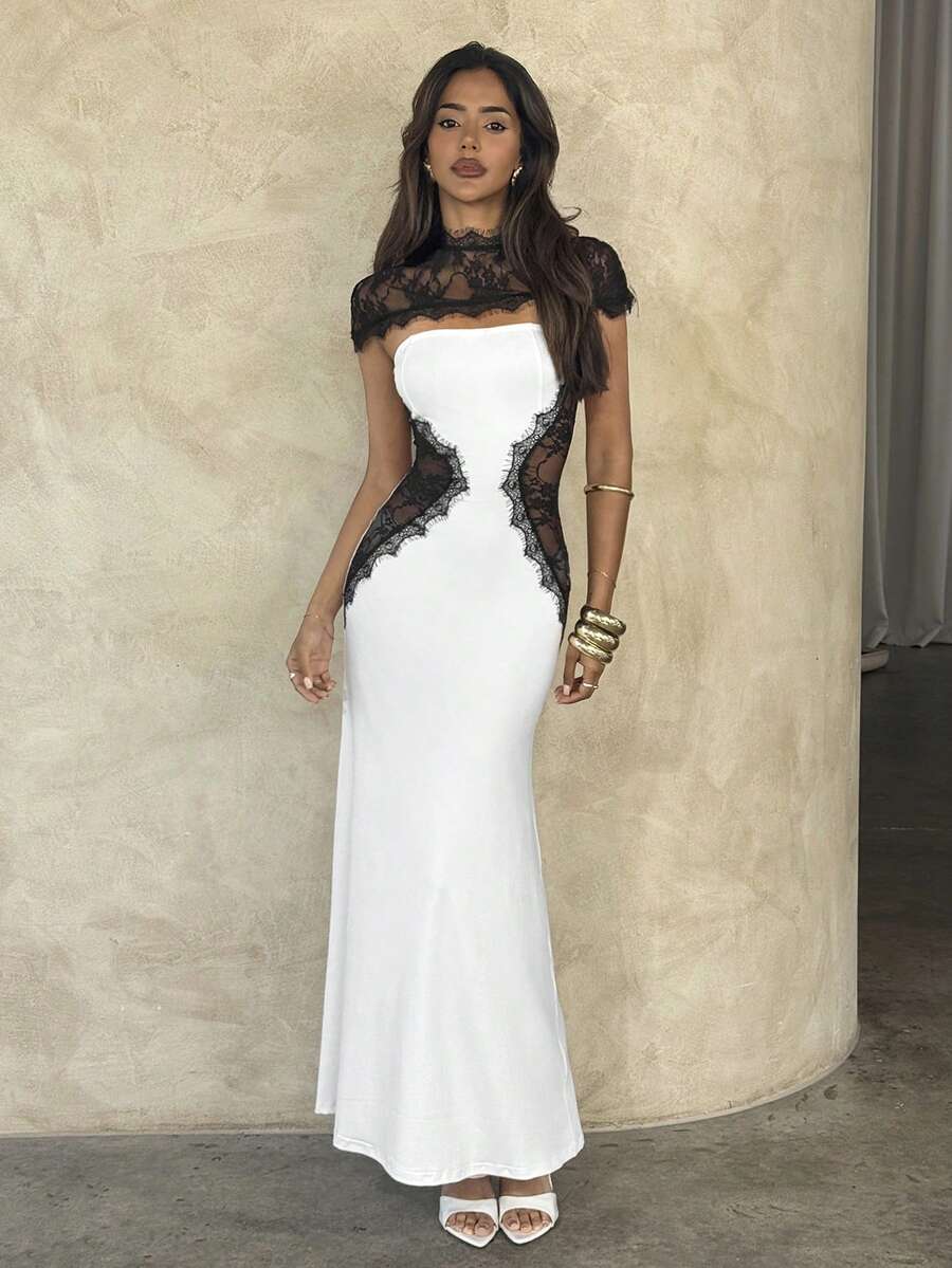 Front view of black and white lace patchwork bodycon maxi dress with sheer high neck and cap sleeves