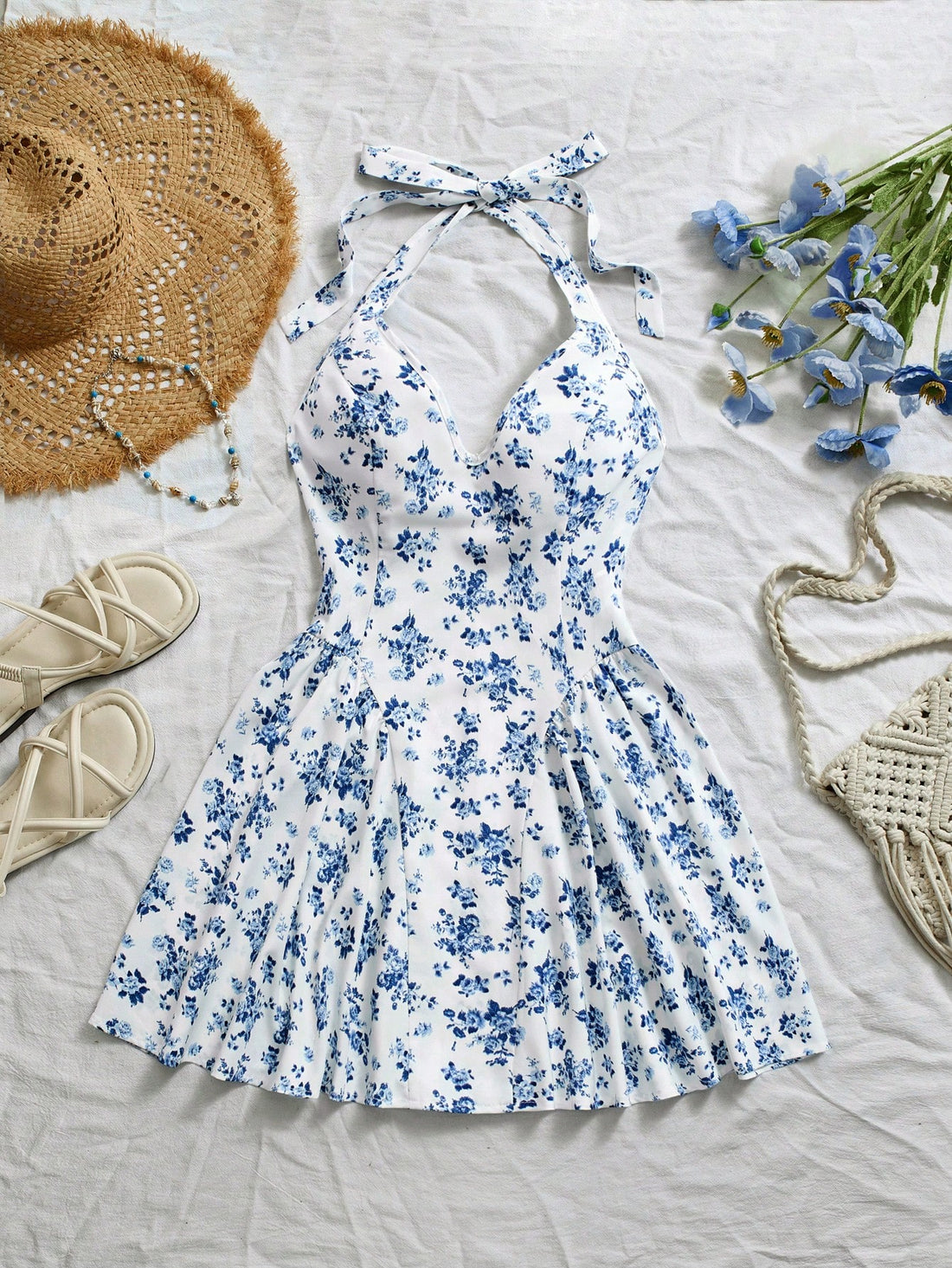 Be bold and flirty in this Blue Ditsy Floral V-Neck Backless Peplum Short Dress! Show off your feminine side with a charming floral print, plunging v-neck, and playful peplum skirt. The backless design adds a touch of sass to this already stunning dress. Perfect for a night out or special occasion.