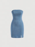Front view of light-wash blue strapless denim mini dress with fitted shape and twin slits