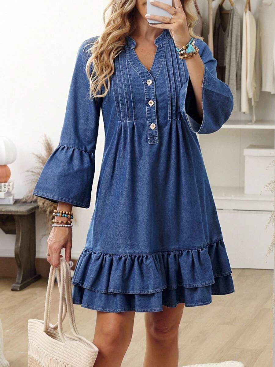 Front view of washed-blue denim mini dress with pintuck bib and double ruffle hem for casual wear