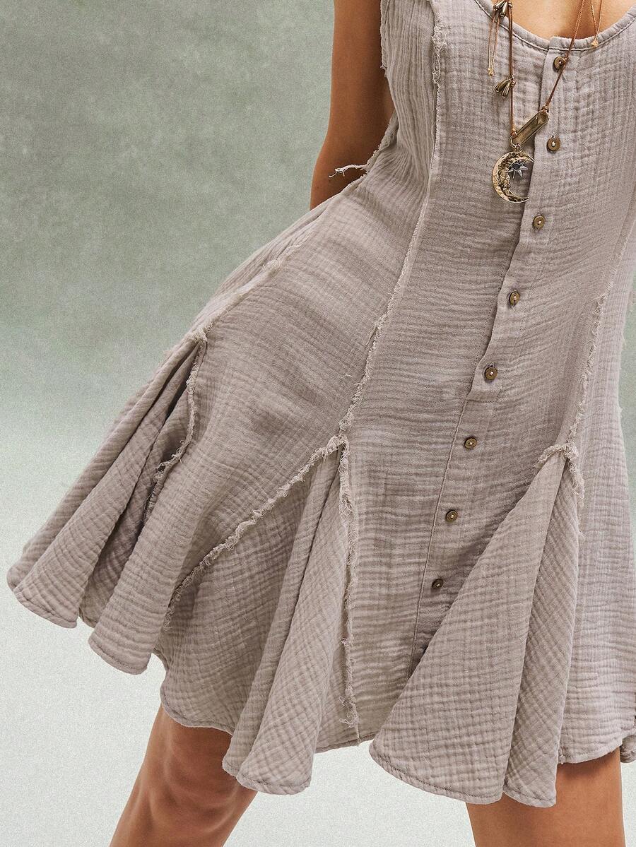 Embrace effortless bohemian style with the Bohemela Boho Mini Dress, featuring a striking patchwork design and playful ruffled hem. This sleeveless A-line dress showcases a scoop neckline, button-front closure, and geometric patterns perfect for warm-weather adventures. Crafted from 100% cotton woven fabric with a natural mid-waist fit, it's ideal for concerts, beach getaways, and festival celebrations. The flared silhouette offers comfortable, casual elegance for any occasion. Machine washable for easy car