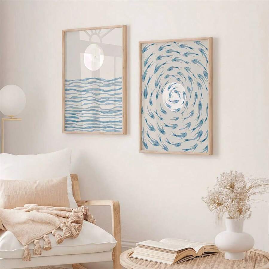 Reading nook view of moon-and-waves and circling-fish coastal wall art in wood frames