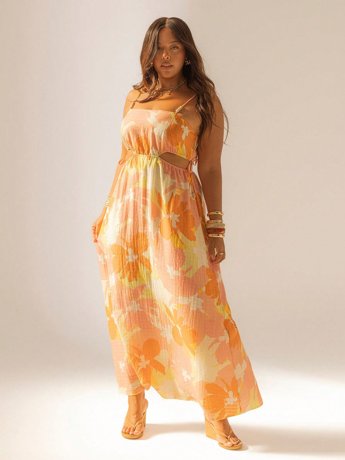 Embrace the sunshine in this Bohemian Floral Maxi Dress, perfect for summer beach getaways. Featuring breezy cut-outs and playful tie straps, it blends comfort with a fun, free-spirited vibe. Its flowing silhouette and vibrant floral pattern make every step feel like a dance along the shore. Get ready to turn heads and soak up the sun in effortless style!