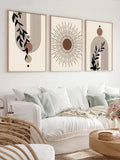Living room mockup of three bohemian sun and botanical prints in light wood display frames