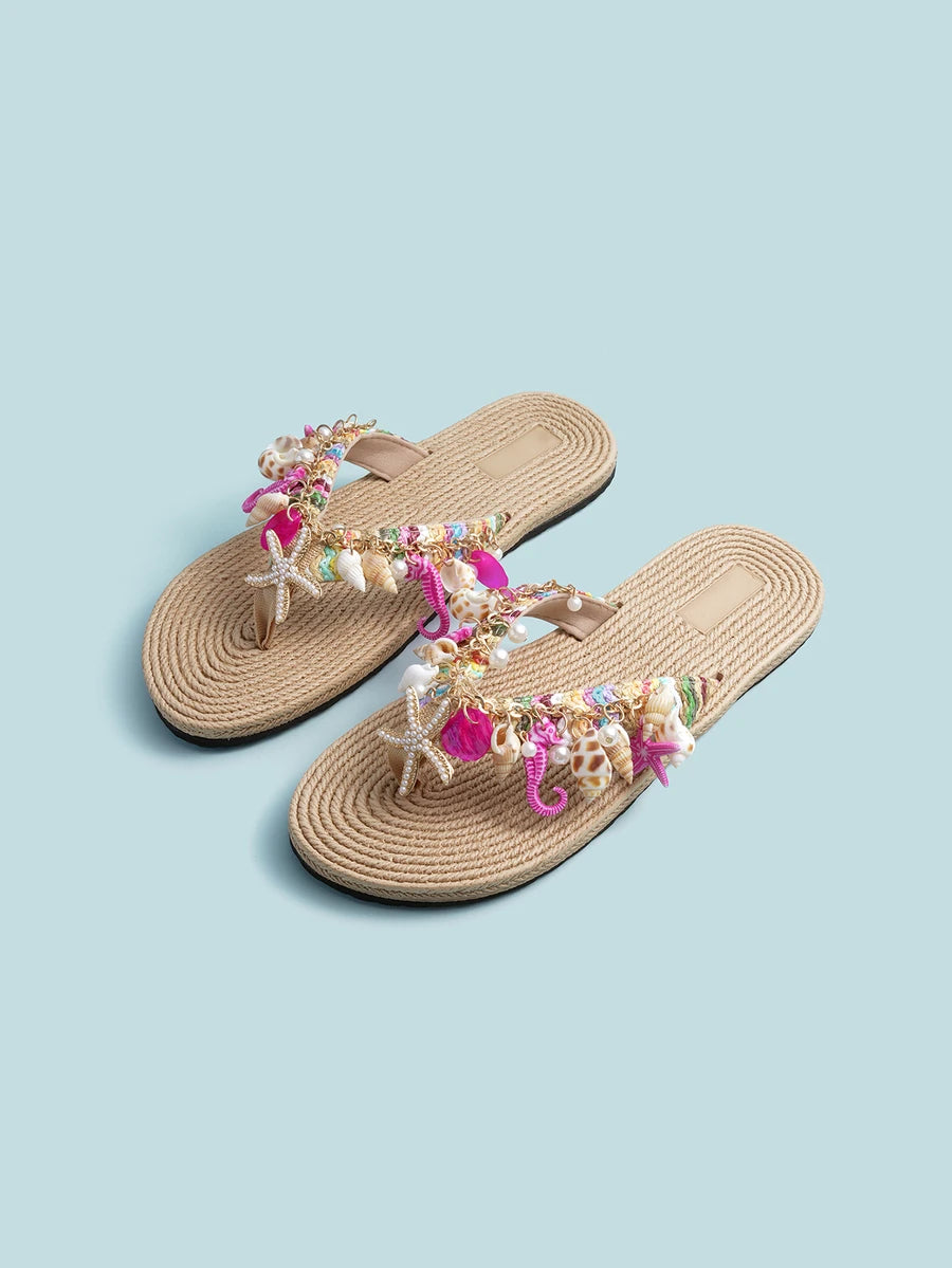 Overhead pair of beige bohemian thong sandals with starfish and pearl-like charms