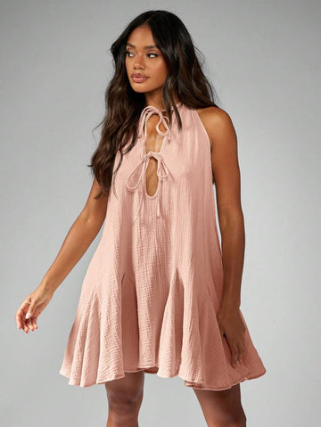 Step into sunshine with this playful Bohemian Tie-Front Mini Dress. Featuring a breezy halter neck and sleeveless design, it’s lightweight for those carefree summer days and easy resort vibes. Perfect for twirling at the beach or dancing under the stars, this dress blends comfort and style effortlessly.