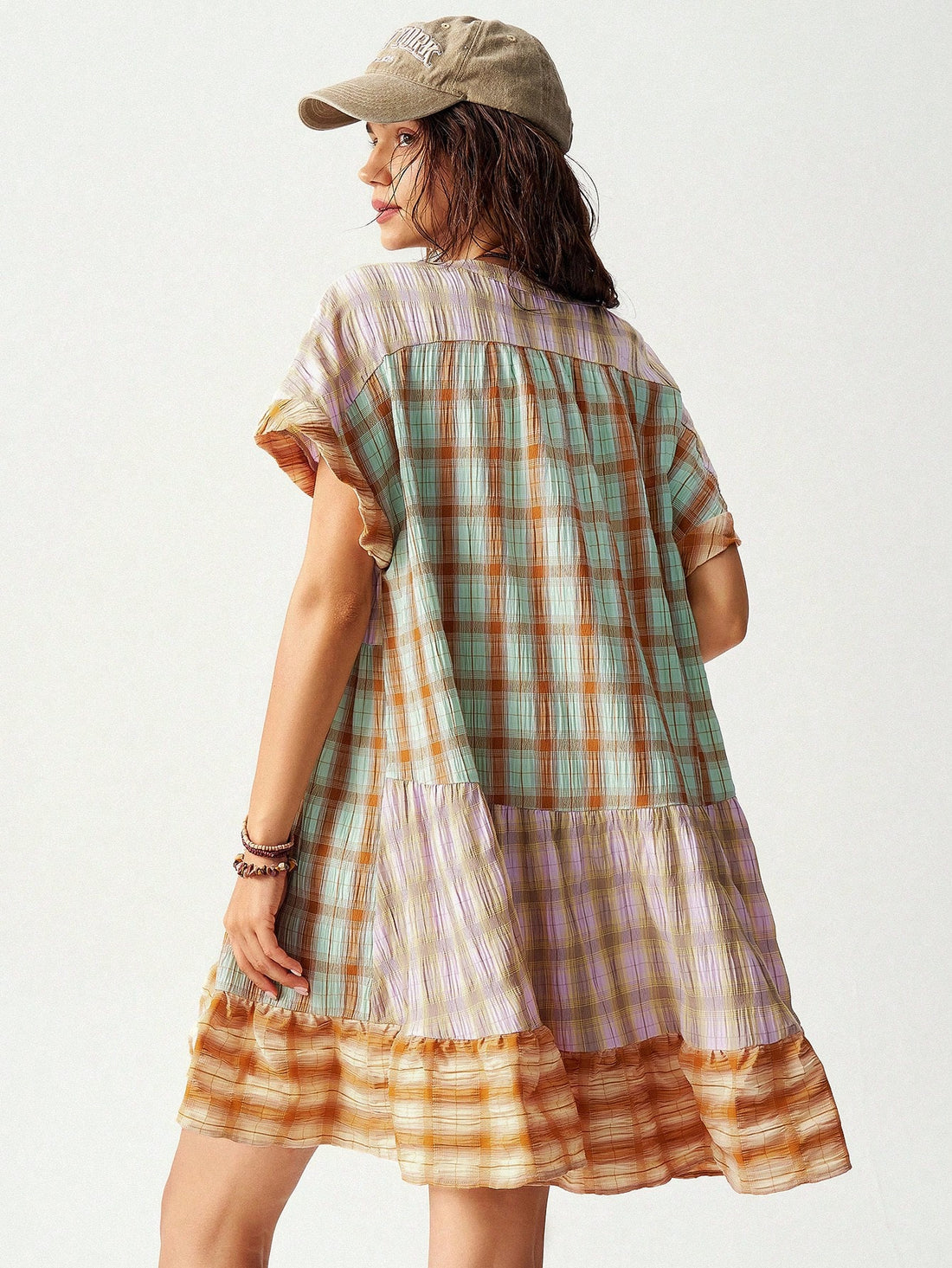 Experience effortless style with Bohemian Vibes: Multi-Colored Plaid Patchwork Vacation Dress. The perfect choice for a chic vacation look, this dress features a stunning combination of vibrant colors and plaid patterns. The patchwork design adds a unique touch to your outfit, while the lightweight fabric keeps you comfortable and cool. Elevate your wardrobe with this must-have dress.