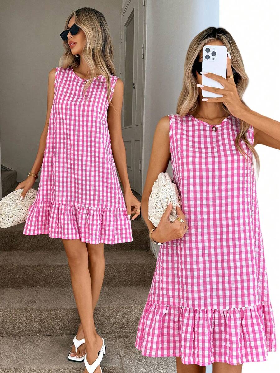 Embrace effortless summer style with this charming pink gingham A-line sundress. Featuring a round neckline, sleeveless tank design, and playful ruffle hem with bow and button details, it's perfect for vacations and everyday adventures. The smock silhouette with low waist and flounce hem creates a flattering, relaxed fit. Made from 100% polyester woven fabric in a regular fit, this cute piece transitions seamlessly from beach days to casual outings. Machine washable for easy care.