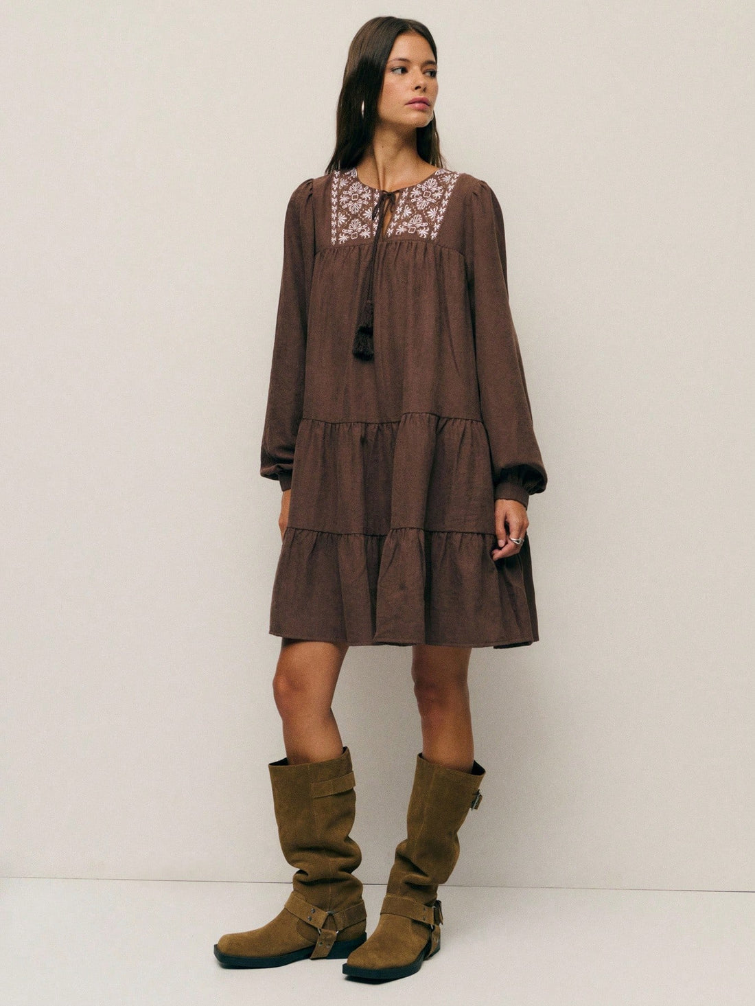 Twirl into autumn with this charming boho-inspired A-line dress that's equal parts whimsical and cozy. Adorned with delicate embroidery and playful tassels, it features an adjustable drawstring waist for the perfect fit. The relaxed silhouette flatters every frame while the earthy aesthetic captures that effortless fall vibe. Whether you're sipping cider at a pumpkin patch or strolling through crisp leaves, this dress brings bohemian flair to your seasonal wardrobe. Embrace the season in style and comfort.