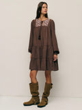 Twirl into autumn with this charming boho-inspired A-line dress that's equal parts whimsical and cozy. Adorned with delicate embroidery and playful tassels, it features an adjustable drawstring waist for the perfect fit. The relaxed silhouette flatters every frame while the earthy aesthetic captures that effortless fall vibe. Whether you're sipping cider at a pumpkin patch or strolling through crisp leaves, this dress brings bohemian flair to your seasonal wardrobe. Embrace the season in style and comfort.