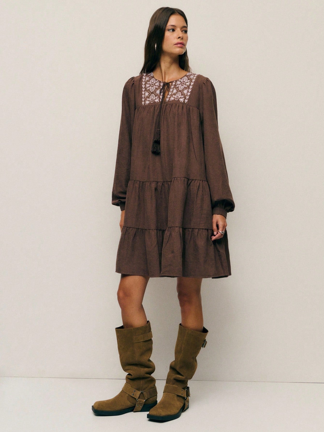 Twirl into autumn with this charming boho-inspired A-line dress that's equal parts whimsical and cozy. Adorned with delicate embroidery and playful tassels, it features an adjustable drawstring waist for the perfect fit. The relaxed silhouette flatters every frame while the earthy aesthetic captures that effortless fall vibe. Whether you're sipping cider at a pumpkin patch or strolling through crisp leaves, this dress brings bohemian flair to your seasonal wardrobe. Embrace the season in style and comfort.