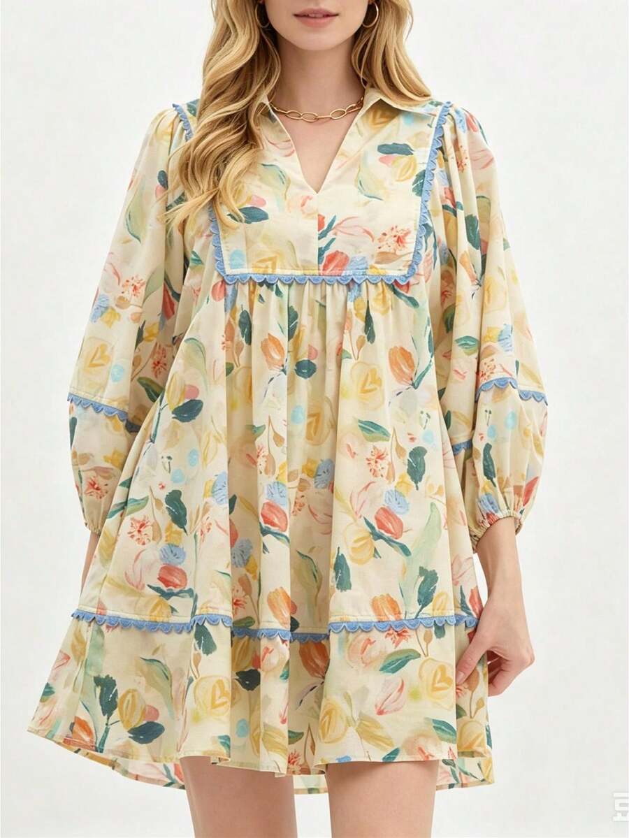 Front view of yellow boho floral babydoll mini dress with blue scalloped trim