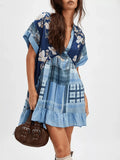 Front three-quarter view of blue floral plaid deep-V mini dress with pale ruffle hem