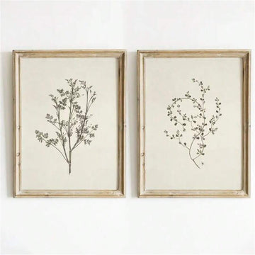 Front wall mockup of two ivory and charcoal botanical prints in distressed gold-tone frames