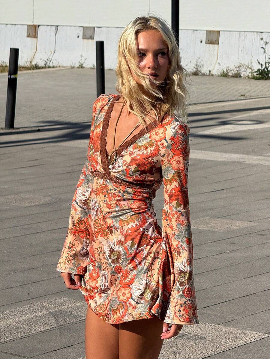 Front three-quarter view of multicolor floral mini dress with lace V-neck and long bell sleeves