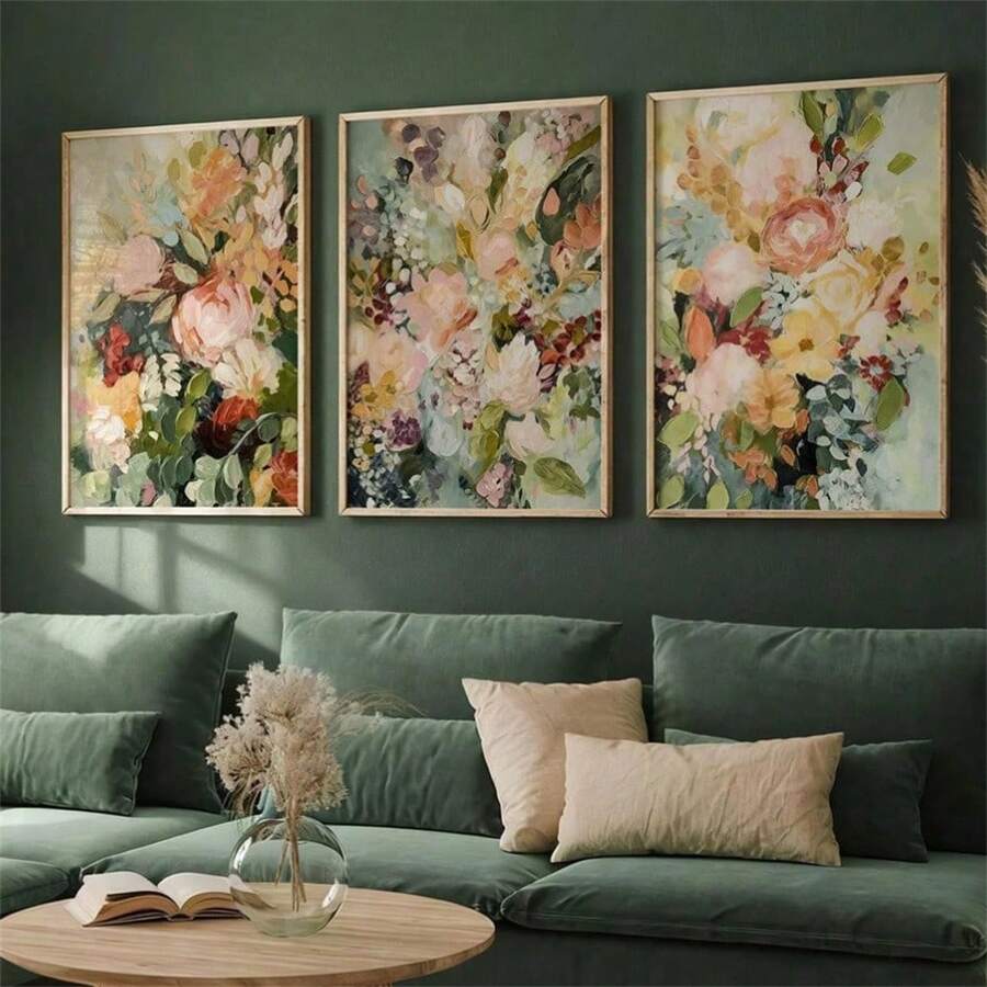 Pastel wildflower canvas triptych in slim frames displayed above a green living room sofa